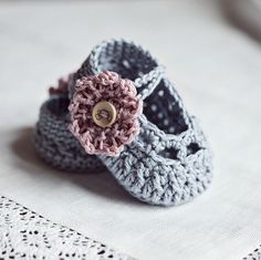 a pair of crocheted baby shoes sitting on top of a table