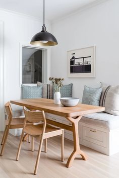 a dining room table with two chairs and a bench