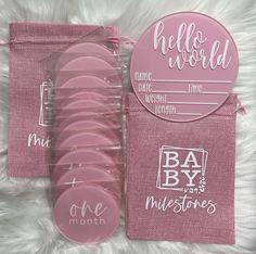 pink baby shower buttons in a package on a white furnishing area with hello world stickers