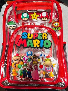 Large Clear Custom Made Super Mario Backpack.  Different color lining available please specify where to place name if personalized. Large Capacity: the clear bookbag measures 17 x 14 x 2.4 inch, which is large enough to meet your needs; 1 main compartment for laptops and books, 2 front compartments for name cards, pencil cases, and glasses, and 2 side mesh pockets to hold water bottles and folding umbrellas Clear Backpack For Back To School, Back To School Clear Backpack, Back To School Clear Backpack For School, Clear Rectangular Backpack For School, Clear Rectangular Backpack For Back To School, Clear Standard Backpack For School, Back To School Clear Rectangular Backpack, Clear Bag For Back To School, Clear Bags For Back To School