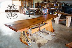 a man is sitting at a table made out of wood