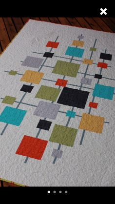 a quilted table runner on a wooden floor