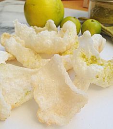 some kind of food that is on a white plate next to green and yellow apples