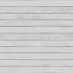 a white wooden wall with planks painted on it