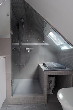 a bathroom with a sink, toilet and shower stall in the middle of the room