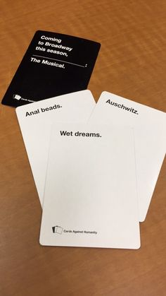 three cards with words on them sitting on a table