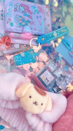 an assortment of toys and other items sitting on a table with confetti scattered around them