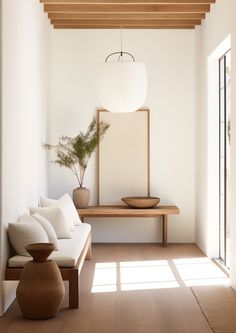 a living room filled with furniture and a large mirror on the wall next to it