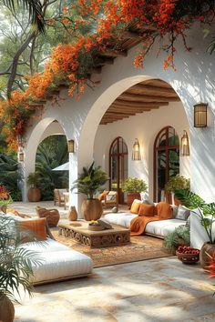 an outdoor living area with couches and potted plants