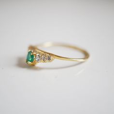 A lustrous pear shape emerald is set with a row of shiny CZs. This ring reminds us of somewhere royal. Handcrafted in 14K solid gold. Materials: - 14K solid gold - Natural 0.20ct pear shape emerald. 4*3mm - Top 5A grade CZ This item is specially made for you. Please allow 1-2 week lead time. Online Return Policy: Due to the made-to-order nature of our jewelry. All products are final sale. Please email us if you are unsure. Gold Emerald Diamond Ring With Pear Shape, Gold Pear-shaped Emerald Diamond Ring, Emerald Gem, Marquise Ring, Lovely Ring, Ring Photos, Dainty Ring, Star Necklace, Opal Rings