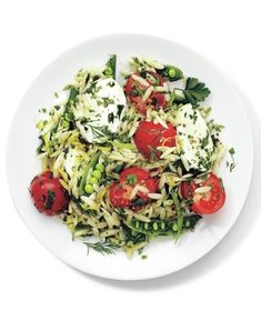 a white plate topped with salad and tomatoes