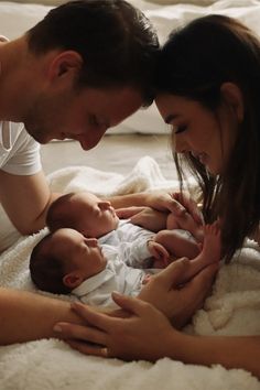 a man and woman are looking at a baby