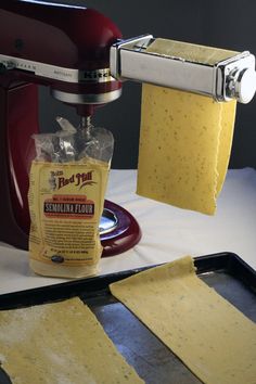 some food is being made in a kitchen with a blender and paper towels on the table