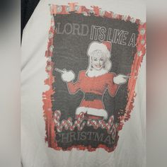 a t - shirt with an image of a santa clause on the front and words, lord it's like a barbeque christmas