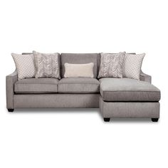 a gray sectional couch with pillows on it