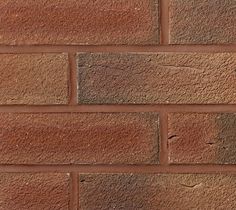 a red brick wall that is very close to the ground