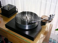 a record player sitting on top of a wooden table