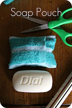 a pair of green scissors sitting on top of a wooden table next to a soap bar