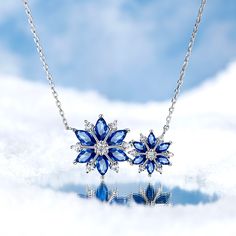 Every winter, we look forward to the first sight of a snowflake. Enjoy the beauty year round with this bewitching sterling silver snowflake necklace. The darling design highlights different-sized snowflakes made of twinkling white and blue stones, which enhances her beauty and refreshes her spirit. Wear this beautiful pendant while gathering by the fireplace in winter holidays, or simply to feel cooler on a hot summer day, or just to add a touch of wintry magic to your everyday look. Polished to Snowflakes Jewelry, Minimalist Accessories Jewellery, Snowflake Jewelry, Pretty Crafts, Snowflake Necklace, Dragon Earrings, Winter Jewelry, Blue Stones, Spirit Wear