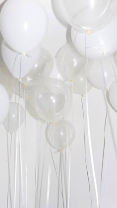 white balloons are floating in the air