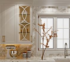 a kitchen with marble counter tops and white cabinets, along with a vase filled with flowers