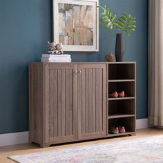 a wooden cabinet sitting on top of a hard wood floor next to a rug and window