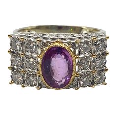 Beautiful 18k white and yellow gold ring, crafted by Buccellati, set with 8.6mm x 6.1mm pink sapphire, surrounded with approx. 0.60ctw in G/VS diamonds. Comes with Buccellati box DESIGNER: Buccellati MATERIAL: 18K Gold GEMSTONE: Diamond, Sapphire RING: STYLE Ring DIMENSIONS: Ring is a size 6 (sizing balls can be removed to increase size) top of the ring is 11mm x 20mm WEIGHT: 8.3g MARKED/TESTED: T 3111, Italy, 18k, Buccellati CONDITION: Estate PRODUCT ID: IN891 Formal Pink Sapphire Ring With Diamond Accents, Formal Gold Sapphire Ring With Pink Sapphire, Formal Pink Sapphire Ring In Yellow Gold, Formal Pink Sapphire Birthstone Ring, Formal Pink Sapphire Ring With Pave Setting, Formal Yellow Gold Pink Sapphire Ring, Formal Hallmarked Pink Sapphire Ring, Beatrice Borromeo Buccellati, Buccellati Earrings