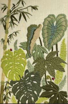 an embroidered picture with leaves and plants on it