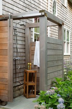 an outdoor shower in front of a house