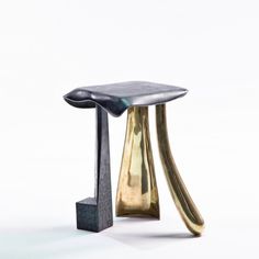 an artistically designed stool sits in front of a white background with no one around it