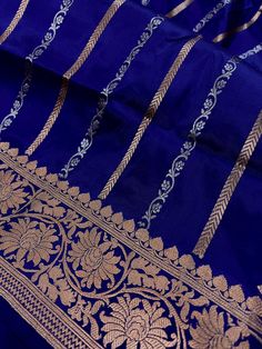 SILK MARK CERTIFIED !!Gorgeous Pure KatanSilk Blue Color with Copper and Slier Zari Work. Strips Sarees in Copper and Sliver Zari with Floral Buttas on the Pallu Soft, light weight and easy to drape Saree. The Strips are dense towards the pallu and get scattered the other end. Item : SareeColor : Blue ColorBase Fabric : Pure Katan Silk Blouse piece : Comes with Blouse pieceBlouse material : Pure Katan SilkFall & Edging (Yes/No) : YesComes with Silk Mark Certificate (Yes/No) : Yes Disclaimer -:- Blue Katan Silk Saree With Self Design, Blue Katan Silk Saree For Diwali, Blue Unstitched Katan Silk Saree, Luxury Blue Katan Silk Saree, Blue Katan Silk Handloom Pre-draped Saree, Banarasi Katan Silk Saree, Katan Silk Saree, Men's Ethnic Wear, Drape Saree