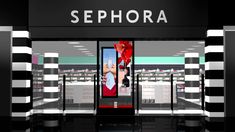 a sephora store front with black and white striped pillars in the foreground, an advertisement for sephora on the wall