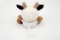 a crocheted stuffed animal sitting on top of a white surface