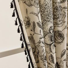 the curtains are decorated with flowers and tassels