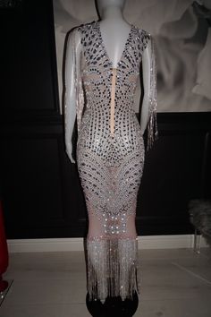 a mannequin wearing a dress with fringes on it