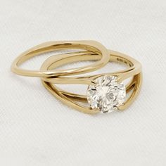 two gold rings with a diamond on top