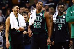 two basketball players are standing next to each other and one is holding a towel in his hand