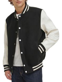 This Dapper Varsity Jacket Comes With A Baseball Collar, Handy Pockets And Contrast Stripe Detailing Around The Neck, The Cuffs And The Hem. Cut To Lend A Regular Fit, Is Perfect To Style With Any Casual, Relaxed Look. Baseball Collar Long Sleeves Ribbed Cuffs & Hem Button Front Waist Welt Pockets Logo Detail Polyester Machine Wash Imported Size & Fit Regular Fit About 27" From Shoulder To Hem. Men's - M Outerwear > Saks Off 5th. Dkny. Color: Black White. Size: M. Varsity Track Jacket With Pockets For Fall, Hooded Outerwear With Button Closure For College, Urban Outerwear With Button Closure For College, Urban Outerwear For College With Button Closure, Trendy Long Sleeve Outerwear With Elastic Cuffs, Winter Outerwear With Baseball Collar And Contrast Cuffs, Fall Cotton Outerwear With Baseball Collar, Casual Cotton Outerwear With Striped Cuffs, College Style Fall Outerwear With Pockets