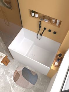 an aerial view of a bathroom with a bathtub and rugs on the floor