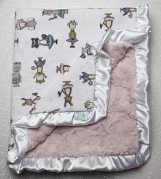 a pink and white blanket with cartoon characters on it