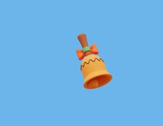 an orange bell with a bow on it is flying in the blue sky and there are no clouds