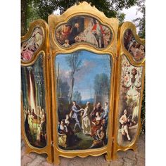 an ornately painted cabinet with many paintings on it