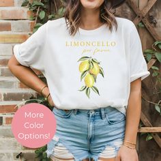 This Limoncello Por Favore Shirt, a delightful blend of style and zest, perfect for those who appreciate the finer things in life. This Lemon T-Shirt combines a fresh, vibrant design with the playful phrase "Limoncello Por Favore," making it a standout piece in any wardrobe. It's a charming nod to Italy's beloved lemon liqueur, Limoncello, and a stylish way to show appreciation for Italian culture. All of our shirts are made with the highest quality materials and are super soft and cozy! ♥ HOW T White T-shirt With Lemon Print For Summer, Casual Cotton T-shirt With Lemon Print, Yellow T-shirt With Lemon Print For Spring, Casual Lemon Tops For Summer, White Short Sleeve T-shirt With Lemon Print, Short Sleeve Lemon Print Graphic Tee, White Short Sleeve Top With Lemon Print, White Crew Neck T-shirt With Lemon Print, Summer Lemon Print Graphic Tee