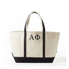 A quality take on a classic, this canvas bag makes an extra cool statement with your house's letters embroidered on the front. Use as an everyday carry-all to get to and from class or as an easy travel tote. Makes a thoughtful gift that any sorority sister will treasure for years to come.    25"w x 9"d x 14"h  Canvas.  Spot clean only.  Imported.  Letters are embroidered. Everyday Bags With Embroidered Logo And Double Handle, Canvas Tote Shoulder Bag With Embroidered Logo, Canvas Shoulder Bag With Embroidered Logo And Double Handle, Canvas Bags With Embroidered Logo And Double Handle, Black Canvas Bag With Embroidered Logo, Rectangular Shoulder Bag With Embroidered Logo For Everyday, Rectangular Shoulder Bag With Embroidered Logo, Rectangular Everyday Shoulder Bag With Embroidered Logo, Classic Black Canvas Bag