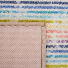 a close up of a rug with a square on it and a small piece of cloth next to it