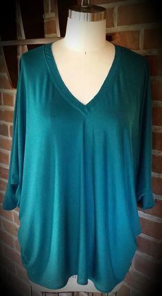 The Versatile Tunic Versatile Green Stretch Blouse, Fitted Green Tunic Tops, Green V-neck Tops For Layering, Green V-neck Tunic For Fall, Green V-neck Tunic For The Beach, Link Green Tunic, Fitted Long Sleeve Green Tunic, Green Flowy V-neck Top, Bohemian Silk V-neck Tunic