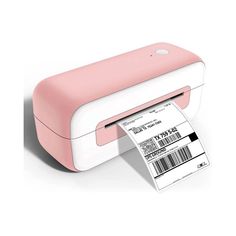 a pink and white printer sitting on top of a table next to a roll of paper