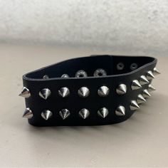 New Unisex Hot Topic Black Chrome Spiked Rocker Biker Bracelet One Size Adjustable Black Punk Wristband, Black Band Wristband For Concerts, Edgy Black Spiked Choker, Adjustable Punk Bracelets For Biker Events, Black Punk Bracelets For Festival, Edgy Band Bracelet For Concerts, Black Punk Festival Bracelets, Edgy Band Bracelet For Concert, Edgy Black Band Bracelets