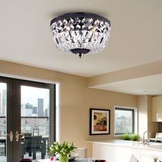 a chandelier hanging from the ceiling above a dining room table