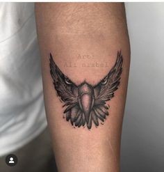 a tattoo with an eagle on the arm and words above it that say art is animals